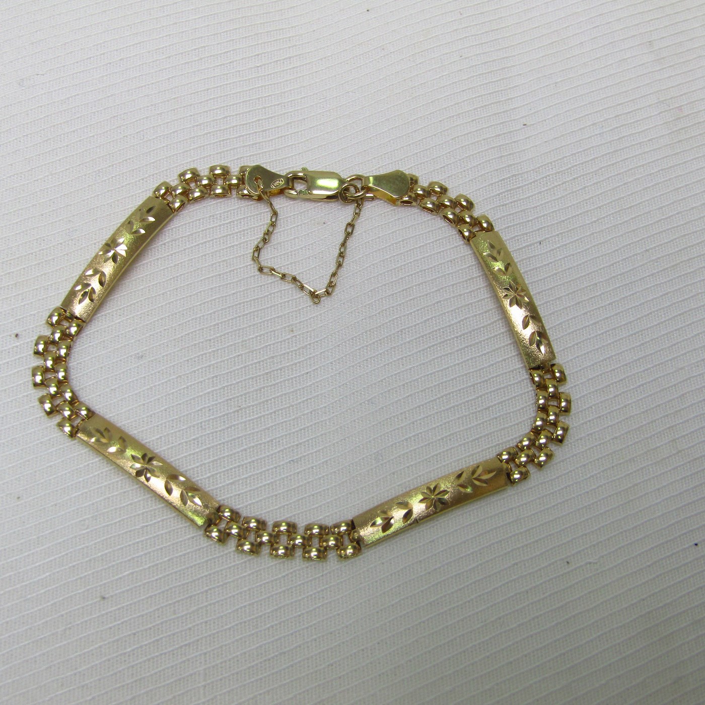 Brazalete articulado en Oro amarillo de 18k con cuatro placas decoradas en oro matizado. 6,98 gr. Brazalete articulado en Oro amarillo de 18k con cuatro placas decoradas en oro matizado. 6,98 gr.