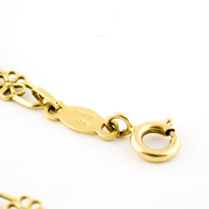 Conjunto de collar y pulsera en oro de 18k. Con eslabones calados.
