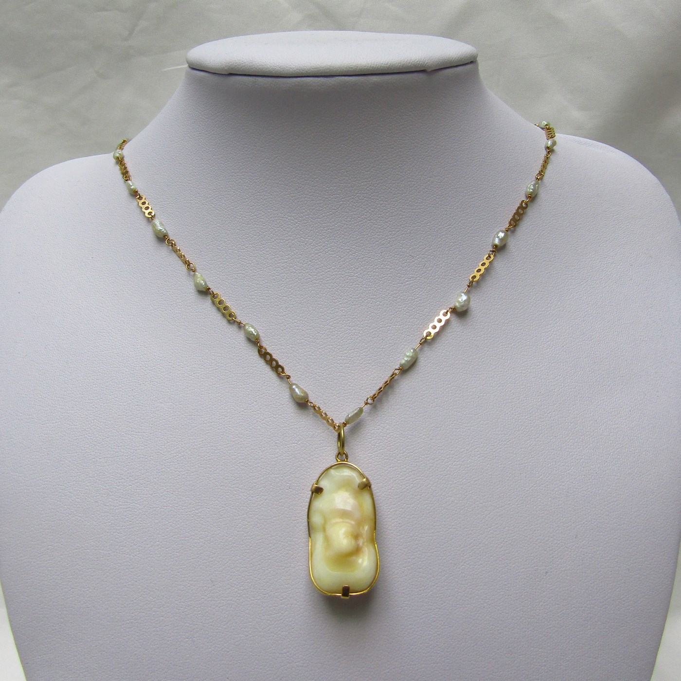 Gargantilla en Oro y Perlas Barrocas con amuleto (Otolito o Hueso de Corvina). Gargantilla en Oro y Perlas Barrocas con amuleto (Otolito o Hueso de Corvina).