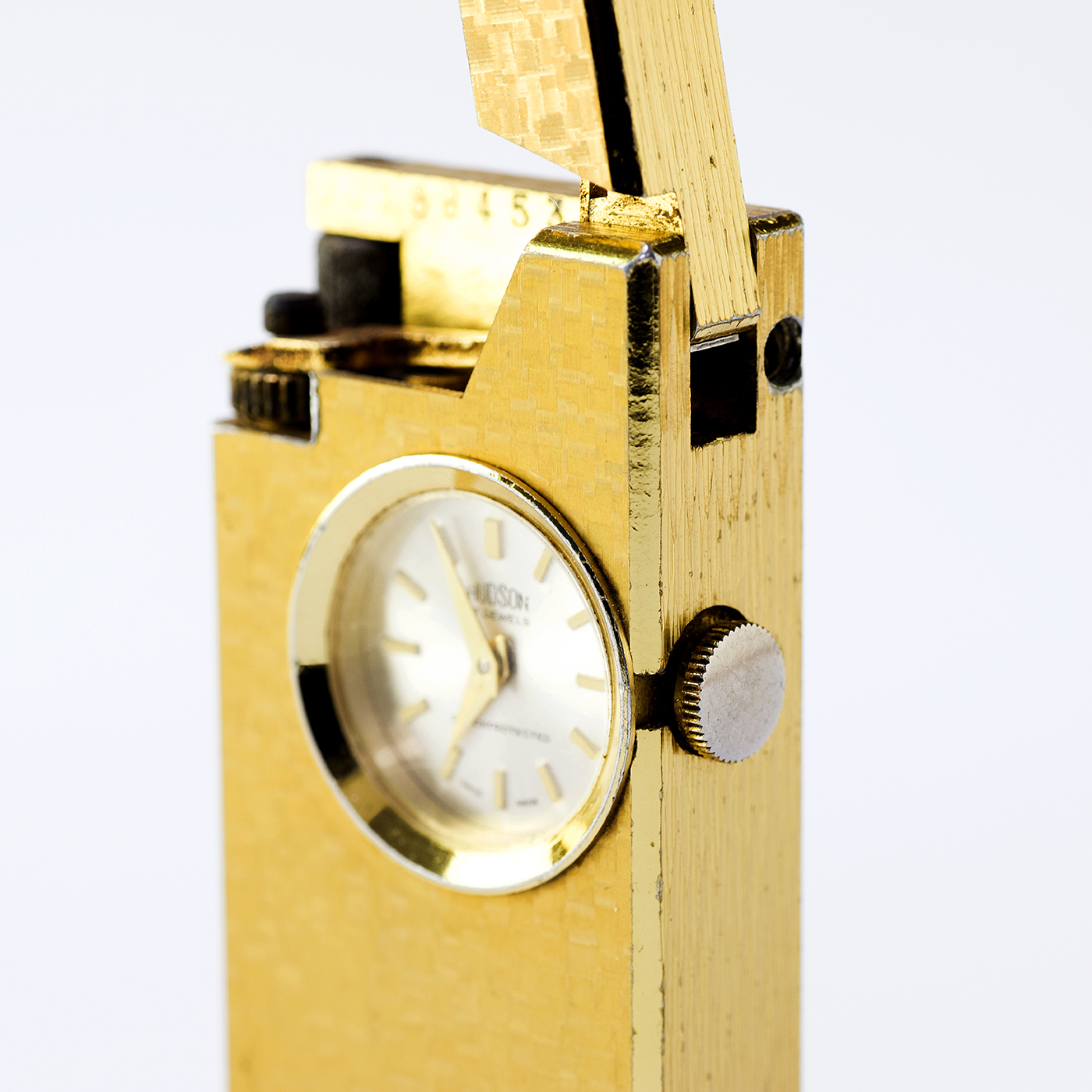 HUDSON (Suiza). Encendedor FOSKA con reloj lepine y remontoir integrado. Suiza, ca.1900.