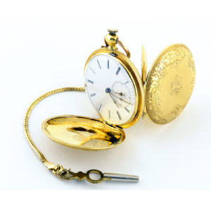 HUGUENIN. Reloj de bolsillo y colgar, saboneta. Circa, 1890.