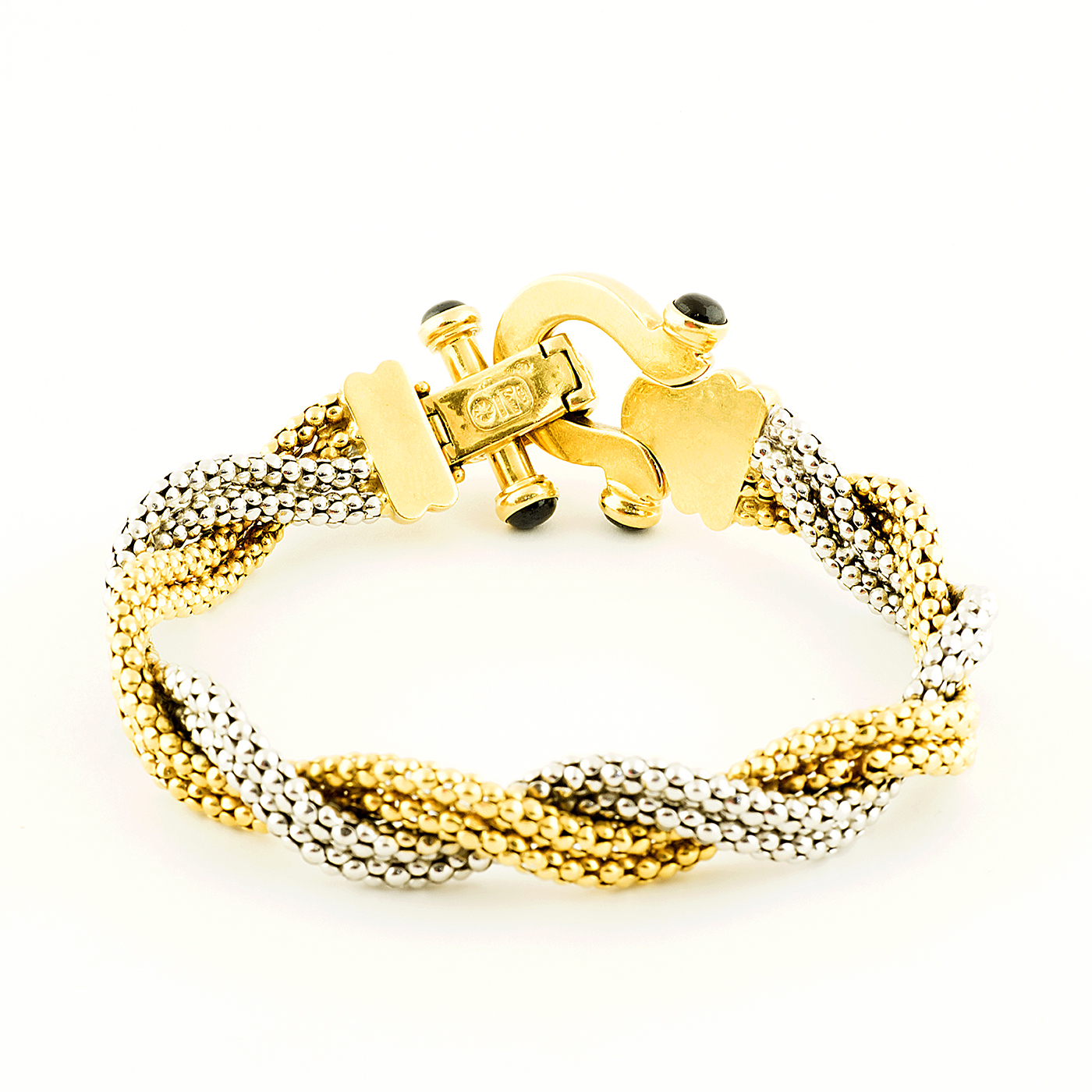 Pulsera en Oro Bicolor trenzada, con cabujón de zafiros. Pulsera en Oro Bicolor trenzada, con cabujón de zafiros.