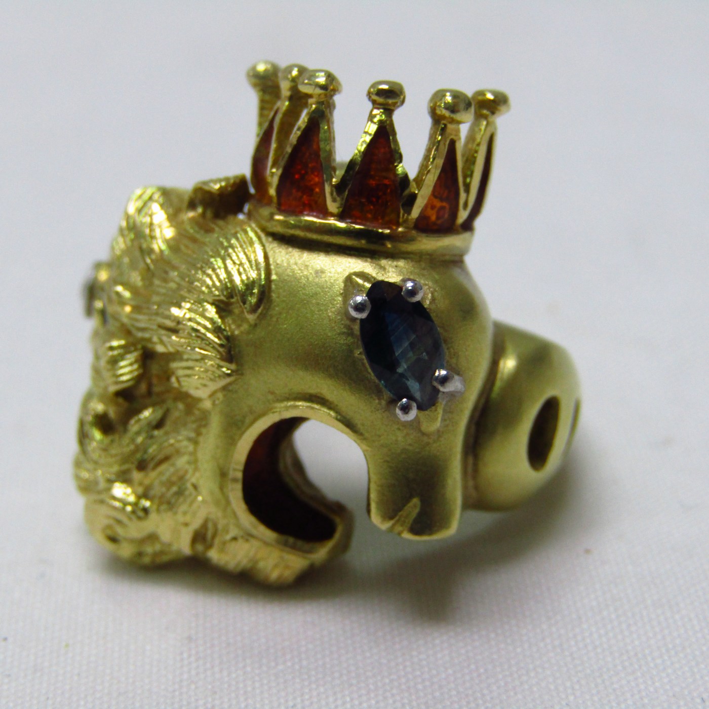 Sortija artesanal realizada en Oro de 18k con forma de felino coronado, con esmalte, zafiro y brillante. 12,54 gr. Sortija artesanal realizada en Oro de 18k con forma de felino coronado, con esmalte, zafiro y brillante. 12,54 gr.