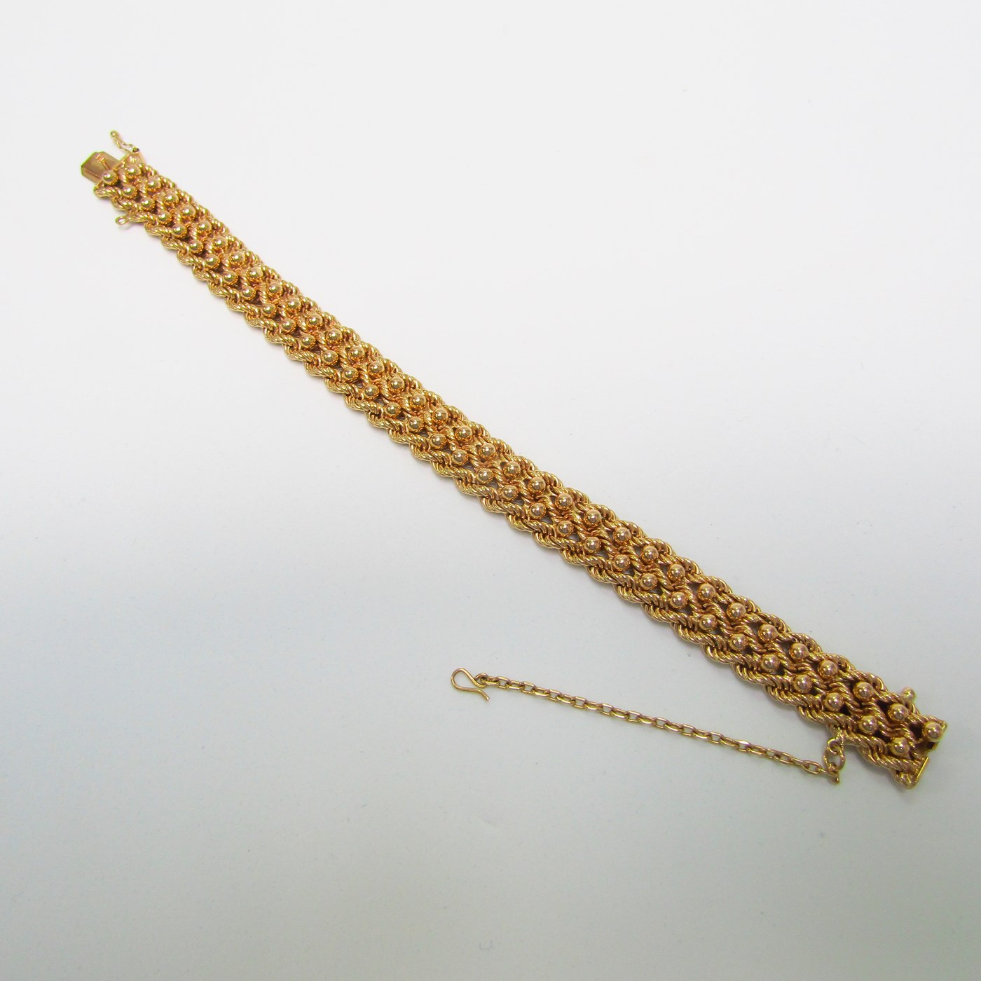 Pulsera de Oro, diseño tipo cordón con figuras de perlas. 18k. Pulsera de Oro, diseño tipo cordón con figuras de perlas. 18k.