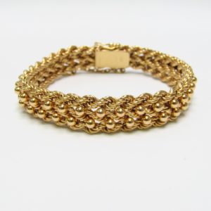 Pulsera de Oro, diseño tipo cordón con figuras de perlas. 18k.
