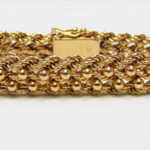 Pulsera de Oro, diseño tipo cordón con figuras de perlas. 18k.
