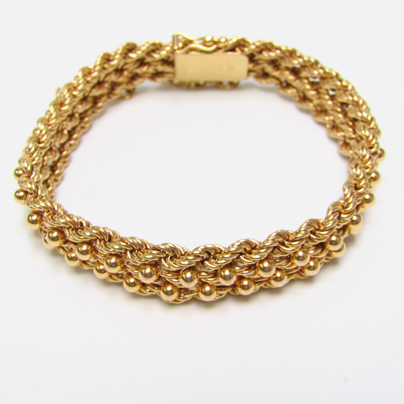 Pulsera de Oro, diseño tipo cordón con figuras de perlas. 18k. Pulsera de Oro, diseño tipo cordón con figuras de perlas. 18k.