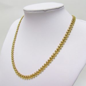Collar articulado en Oro Amarillo, doble cara. Peso 27,5 gr.