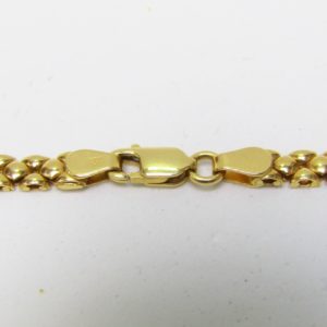 Collar en Oro Amarillo visto y matizado de 18k con apliques decorados. Peso 15,43 gr.
