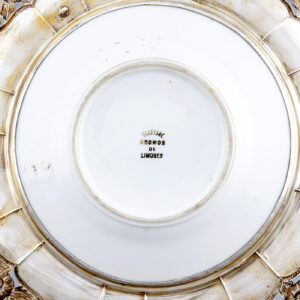 Pareja de Platos en Porcelana Limoges y Plata de Ley. España. Siglo XX.