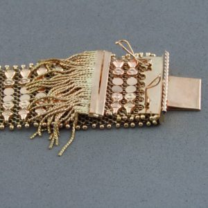 Pulsera ancha en Oro de 18k con flecos. 58 gr.