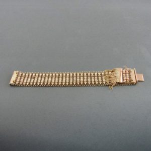 Pulsera ancha en Oro de 18k con flecos. 58 gr.