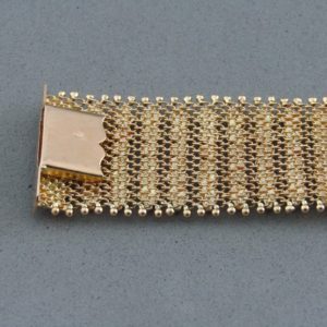 Pulsera ancha en Oro de 18k con flecos. 58 gr.