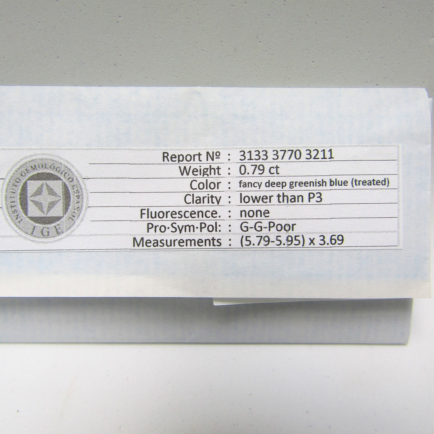 Diamante Natural de 0,79 ct. Talla: Brillante. Color: Fancy deep greenish blue. Pureza: P3. Tratado. Certificado IGE. Diamante Natural de 0,79 ct. Talla: Brillante. Color: Fancy deep greenish blue. Pureza: P3. Tratado. Certificado IGE.