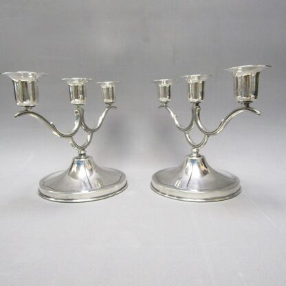 Pair of sterling silver three-light chandeliers. South America. 20th century.