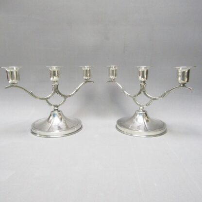 Pair of sterling silver three-light chandeliers. South America. 20th century.