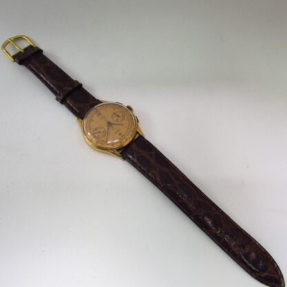 OLYMPIC. Reloj Cronógrafo de pulsera para caballero. Oro 18k. Suiza, ca. 1950.