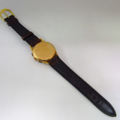 OLYMPISCH. Chronograph Armbanduhr für Männer. 18 Karat Gold. Schweiz, ca. 1950.